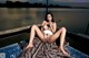 A woman sitting on top of a boat on a lake.