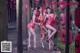 A group of women in red dresses posing for a picture.