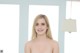 A woman in a strapless dress posing for a picture.